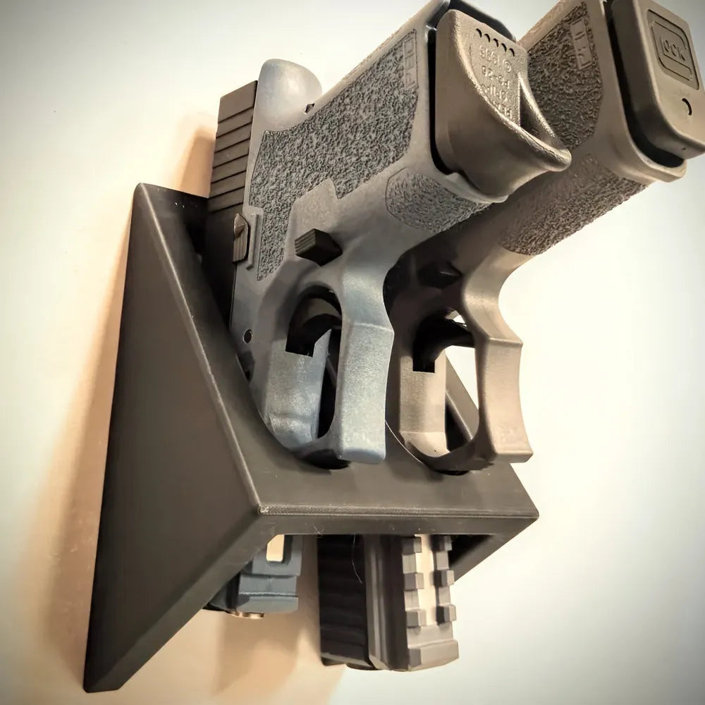 Black plastic punk-style pistol display stand for toy guns and replicas.