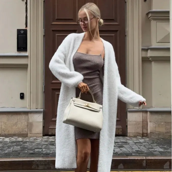 White knit cardigan jacket with extended length on hanger