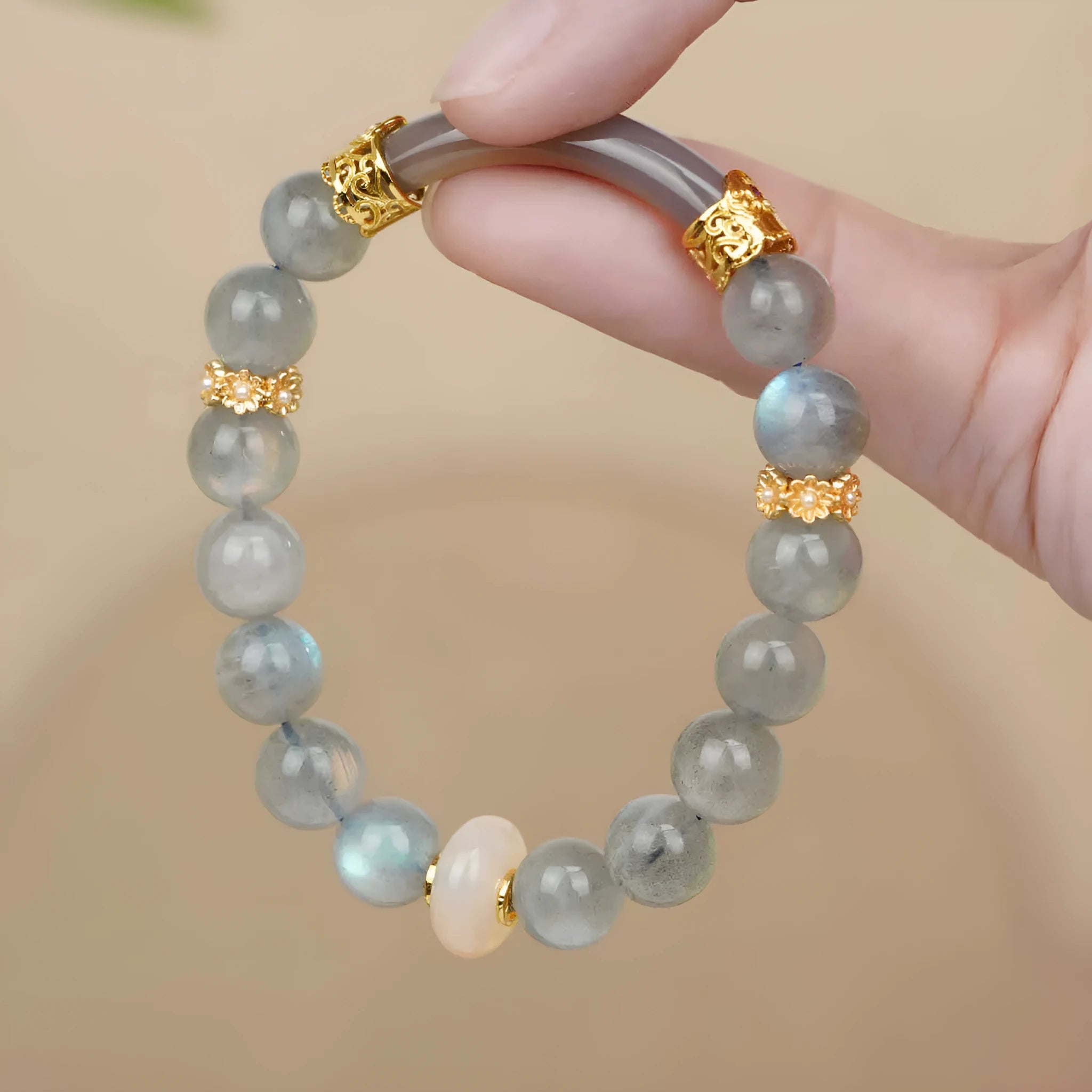 Gray moonstone agate women's half bracelet with 8mm round beads on a wrist.