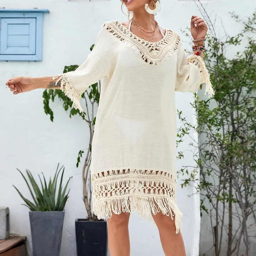 Women's apricot crocheted patchwork beach dress with half sleeves on a hanger.