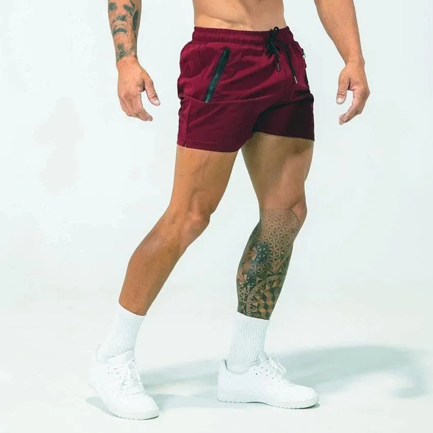 Men's blue quick-dry sports shorts on a hanger showing casual mid-waist design