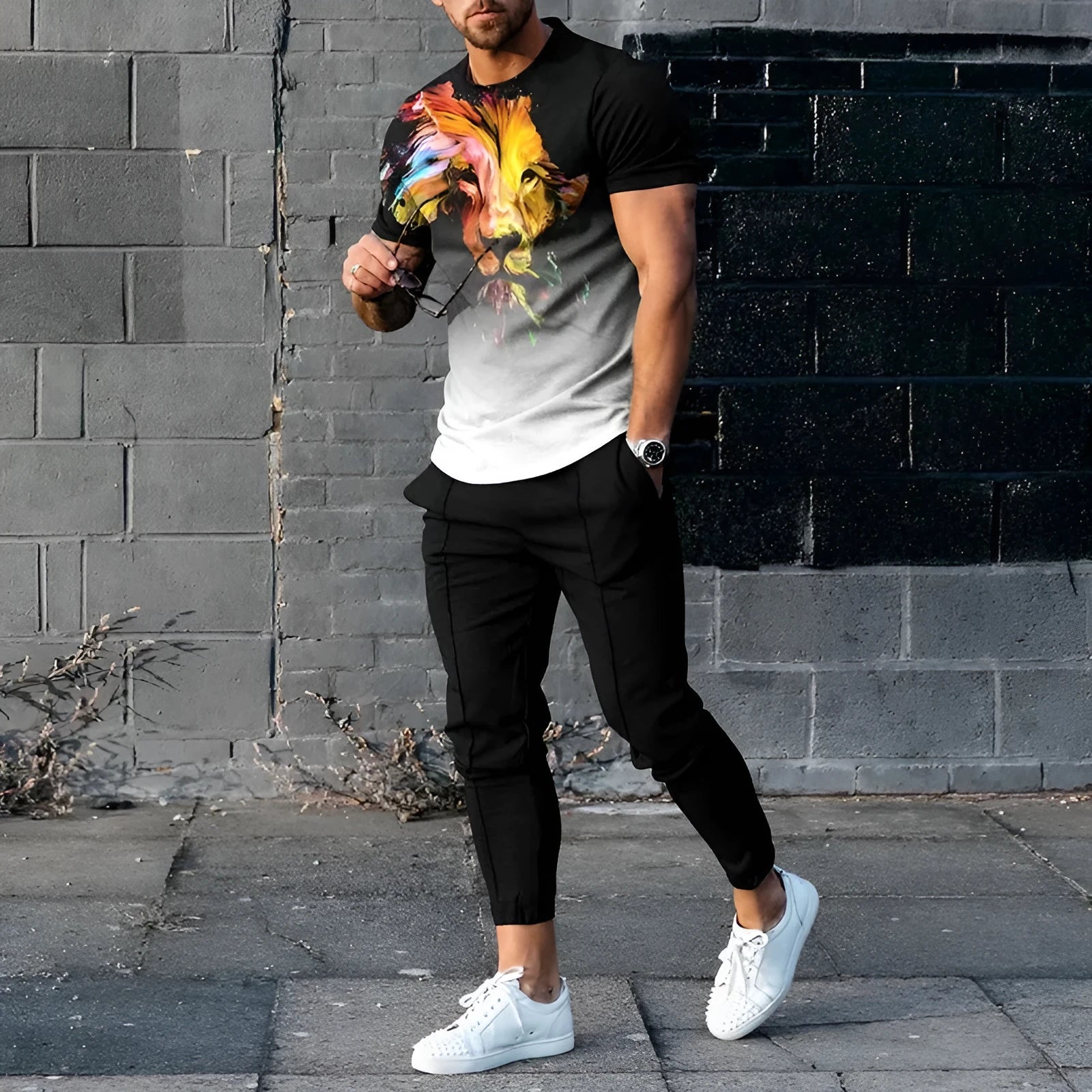 Man wearing a short-sleeved printed pullover and matching trousers from a lightweight polyester casual set.