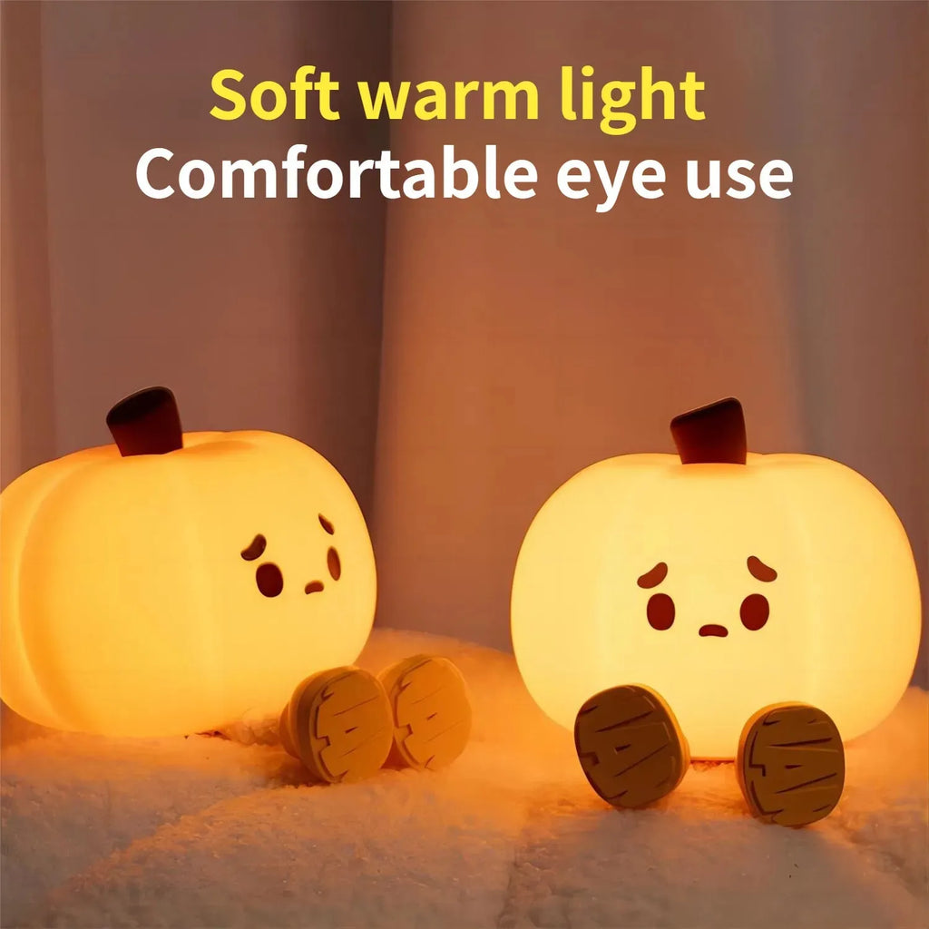 Soft orange silicone pumpkin-shaped night light with a warm glowing LED centre