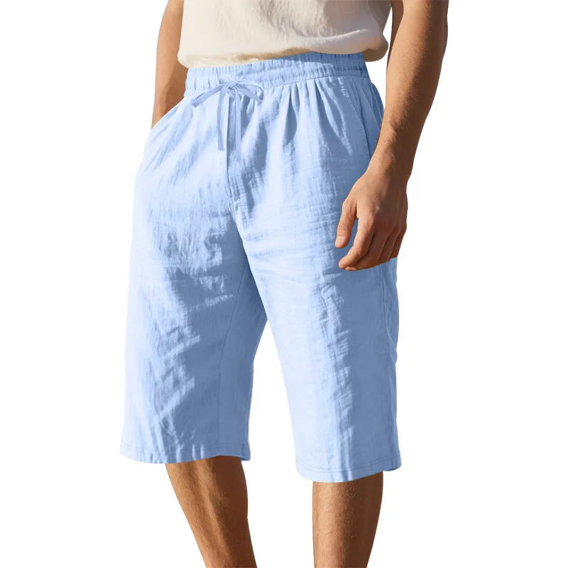 Men's loose fit linen shorts in a solid colour with a high waist and drawstring closure.