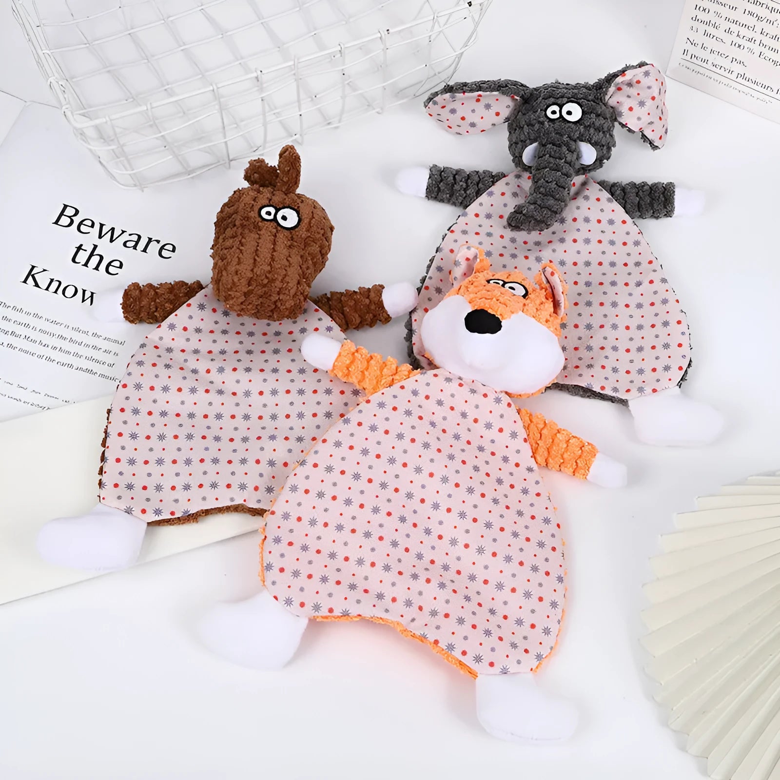 Brown, gray and orange plush pet toys in fox and elephant shapes with velvet texture