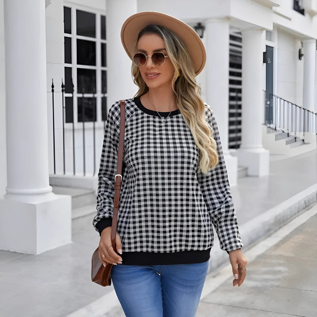 Black long sleeve pullover sweater with a striped plaid pattern, showing regular sleeve cut.