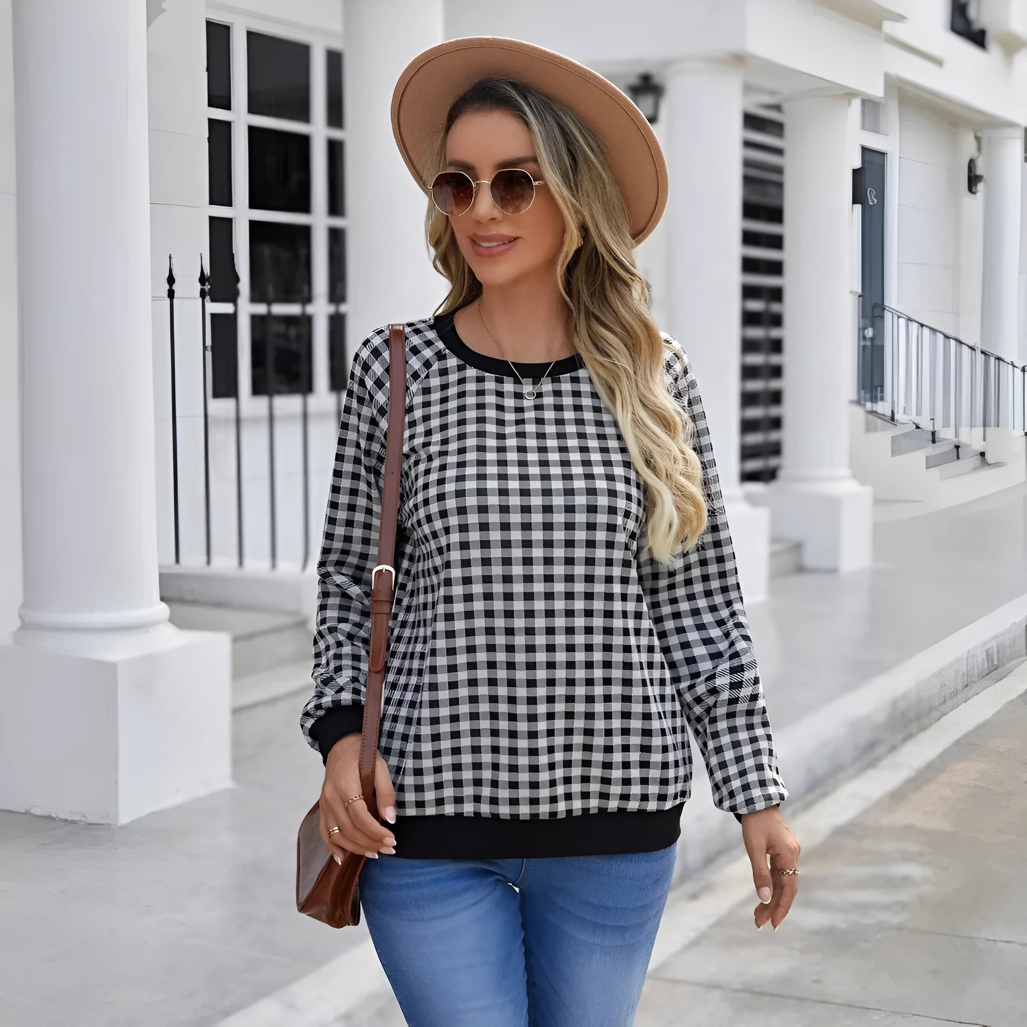 Black long sleeve pullover sweater with a striped plaid pattern, showing regular sleeve cut.