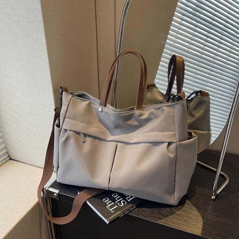 Nylon crossbody tote bag for women in black, shown with crossbody strap.