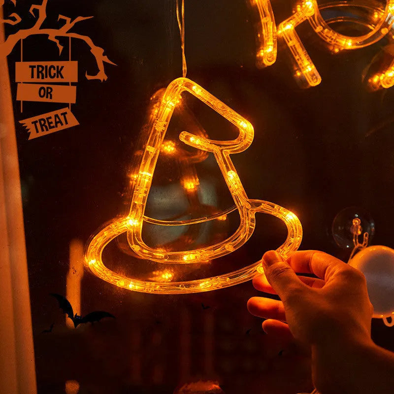 Halloween window hanging LED lights set with seven plastic decorations including spider, pumpkin, and ghost designs