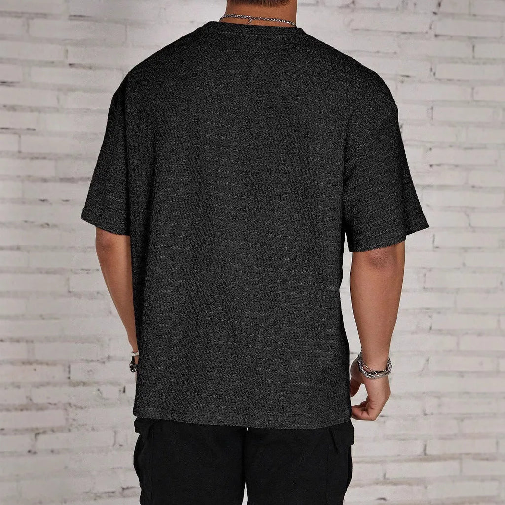 Men's slim fit solid colour short sleeve polyester T-shirt on a hanger.