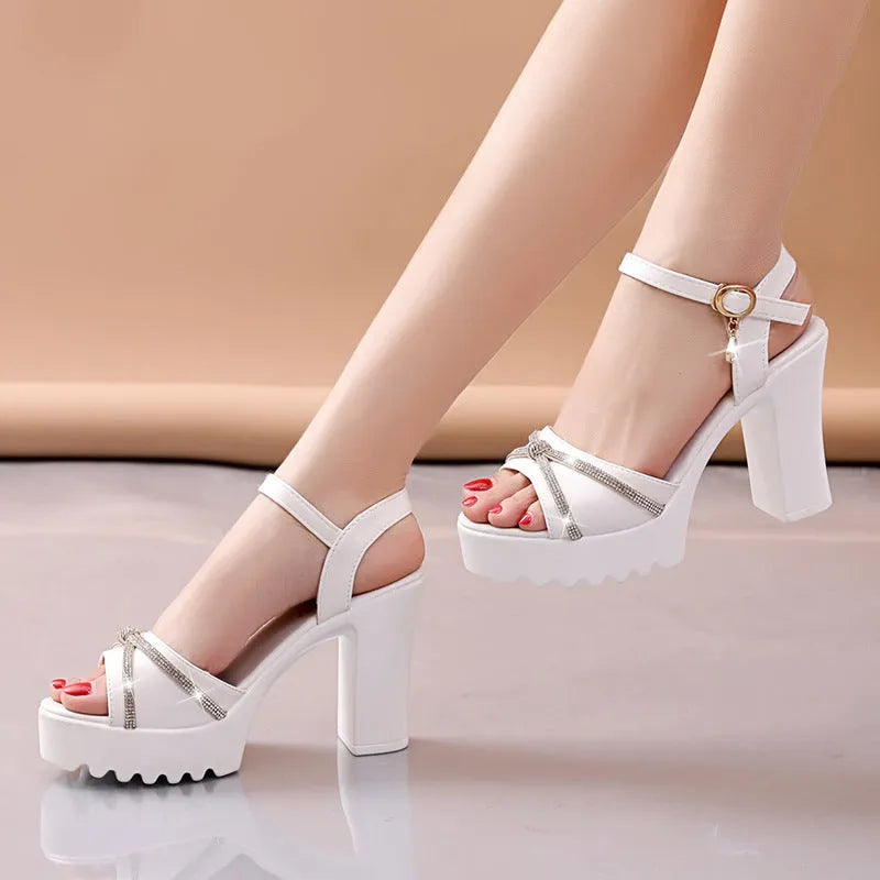 Women's black high heel sandals with strappy PU leather upper on a white background.