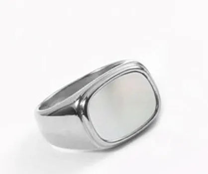 Silver white fashion ring with glossy finish and simulated diamond centre stone on light background
