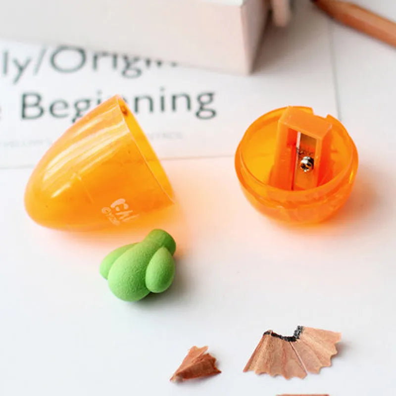 Carrot-shaped plastic manual pencil sharpener with extended handle on a white background.