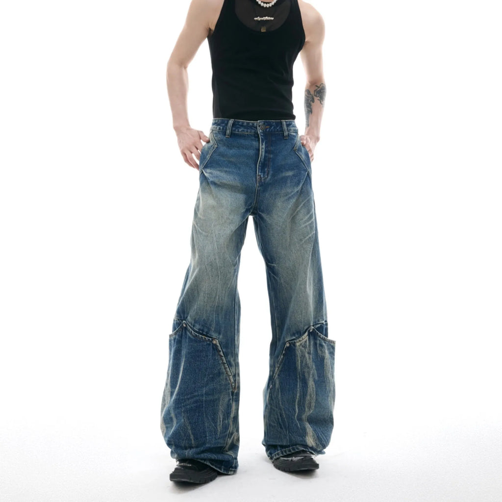 Men's verdant blue jeans with a retro washed burst pattern and curved knife details, shown in a loose fit.