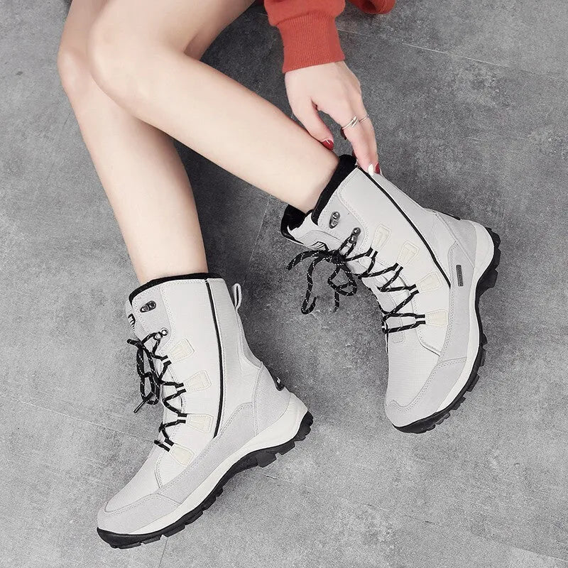 Women's white genuine leather mid-calf snow boots with a round toe and rubber sole on a plain background.