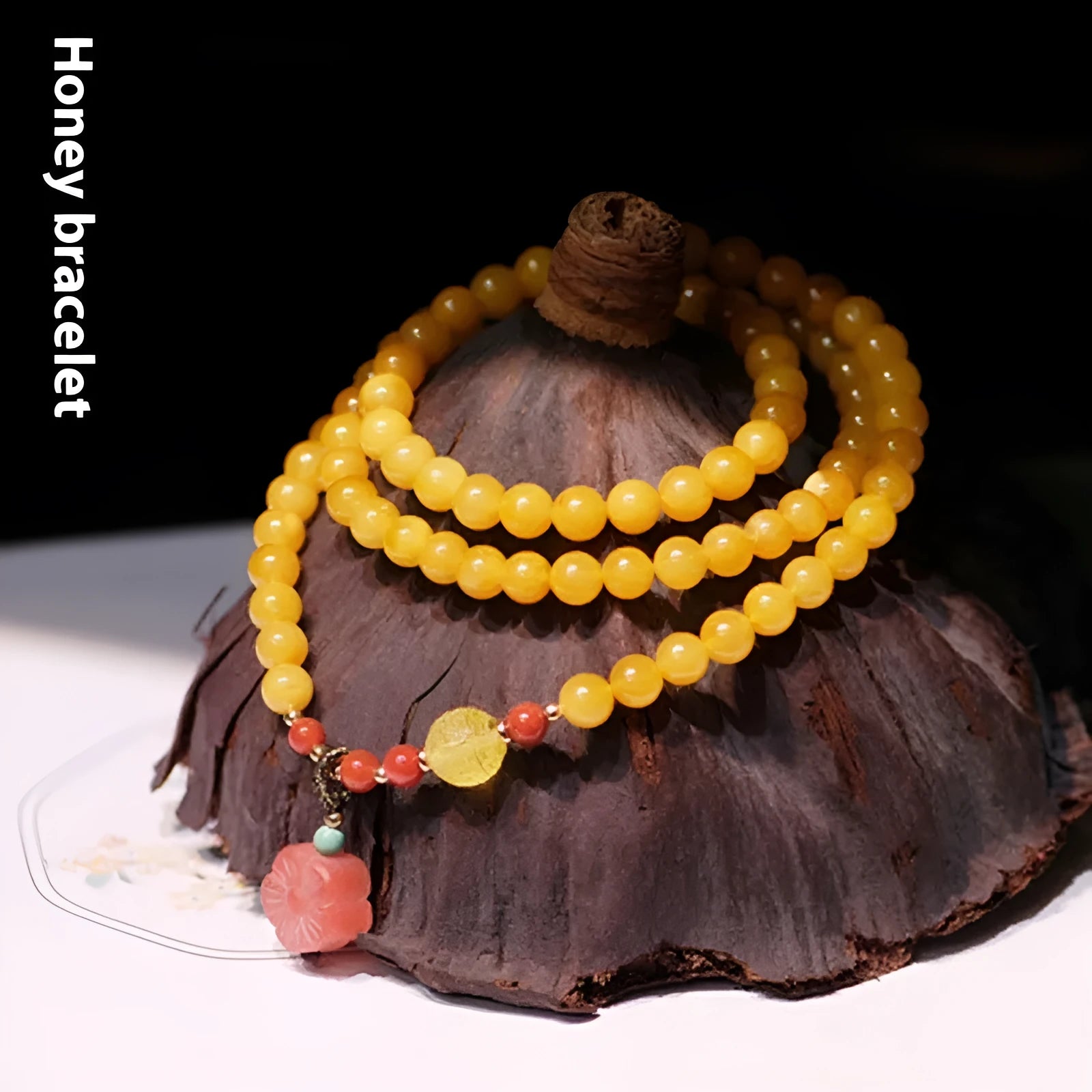Yellow amber bracelet with 5mm round shape and animal zodiac design in retro style.