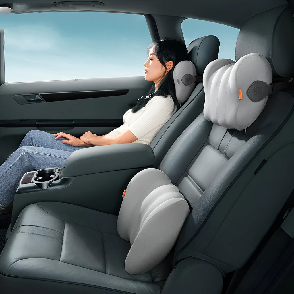 Grey and orange memory foam car head pillow and lumbar support pillow set on a car seat.