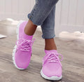Women's breathable lace-up sneaker in a low-top style with a flat rubber sole.
