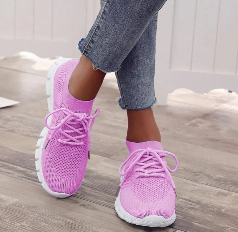Women's breathable lace-up sneaker in a low-top style with a flat rubber sole.