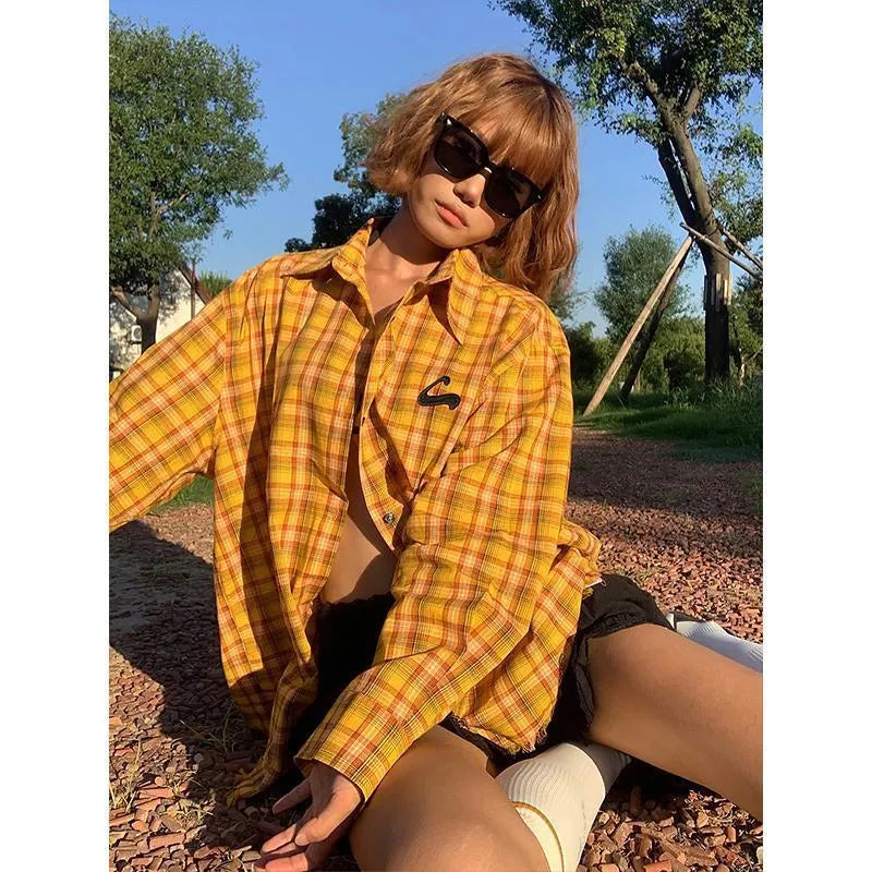 A loose-fitting dopamine yellow plaid shirt with a cardigan style, shown on a hanger.