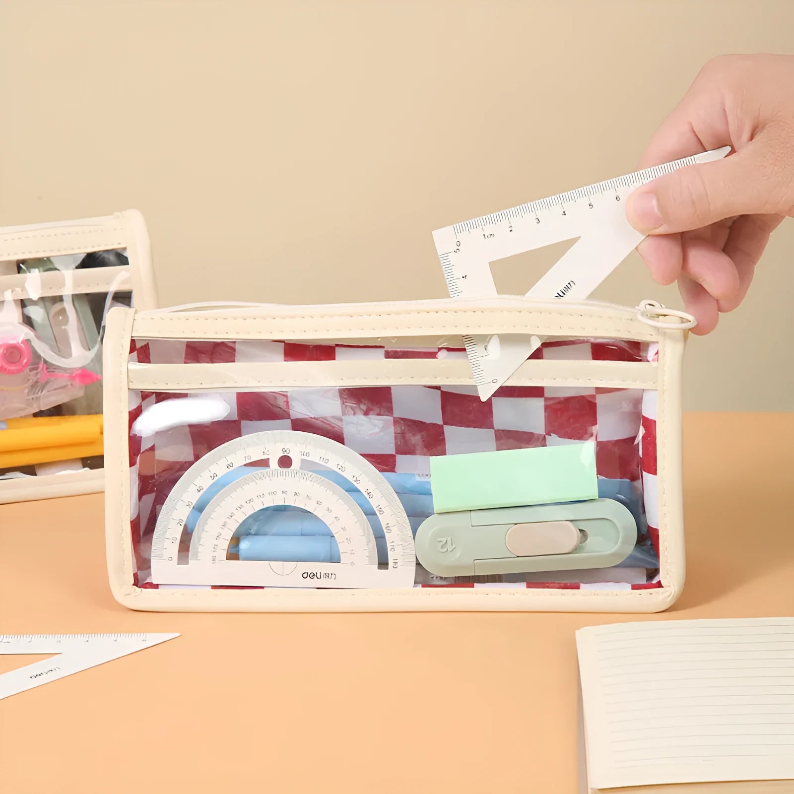 Transparent PVC pencil case with chessboard pattern, showing pens inside, dimensions 21.5cm by 8cm by 11.5cm