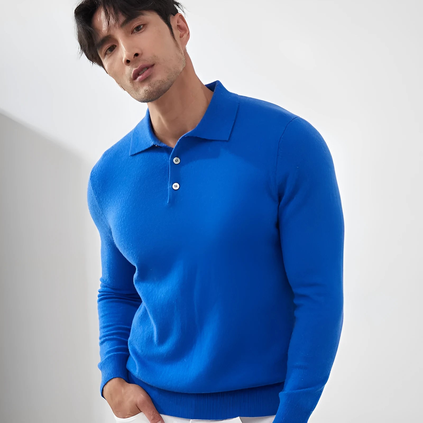 Man wearing a sapphire blue cashmere pullover sweater with a polo collar.