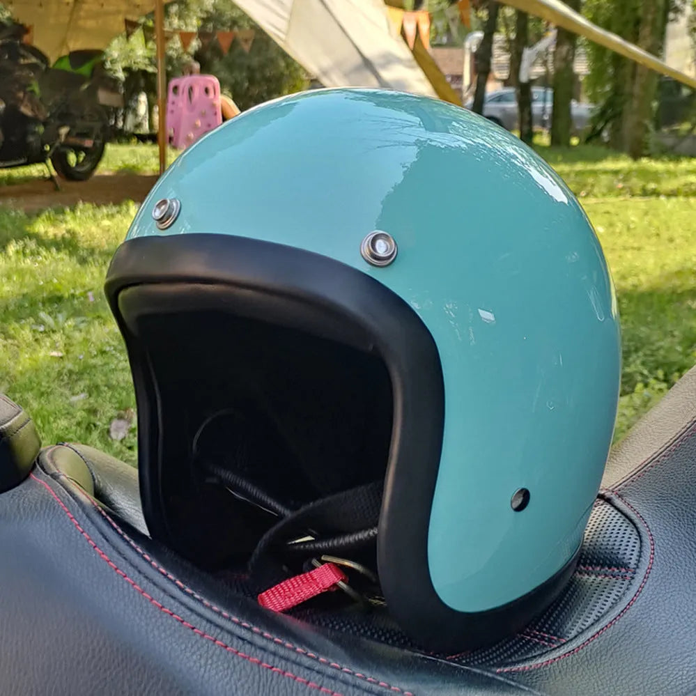 A retro-style fibreglass half motorcycle helmet shown in a cement grey colour, suitable for adult commuting.
