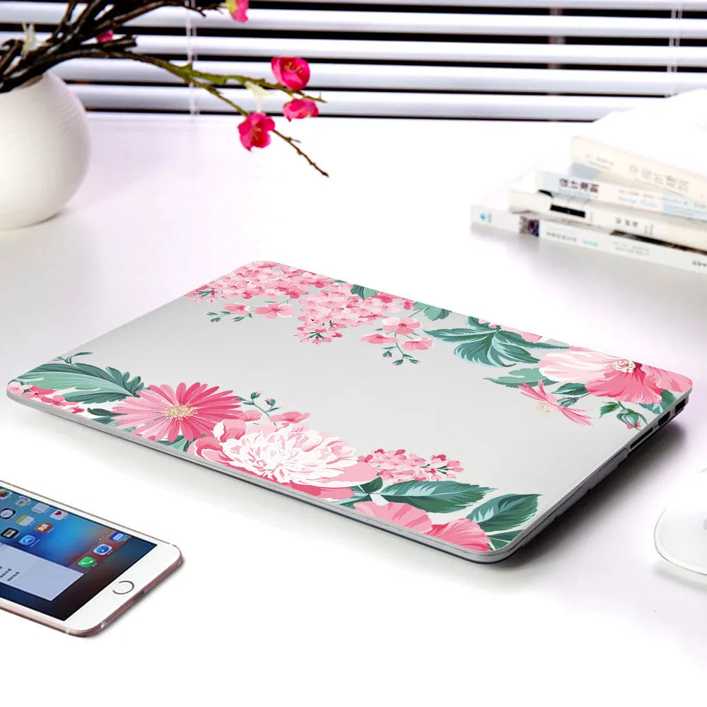 Plastic hard shell case with floral pattern for Apple MacBook Air and MacBook Pro laptops.