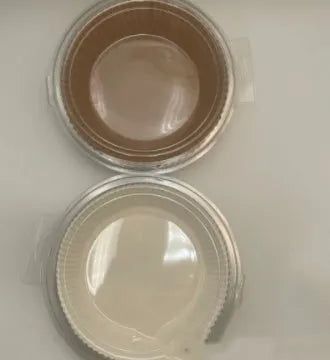 Round white disposable parchment paper liner for air fryer basket with raised edges.