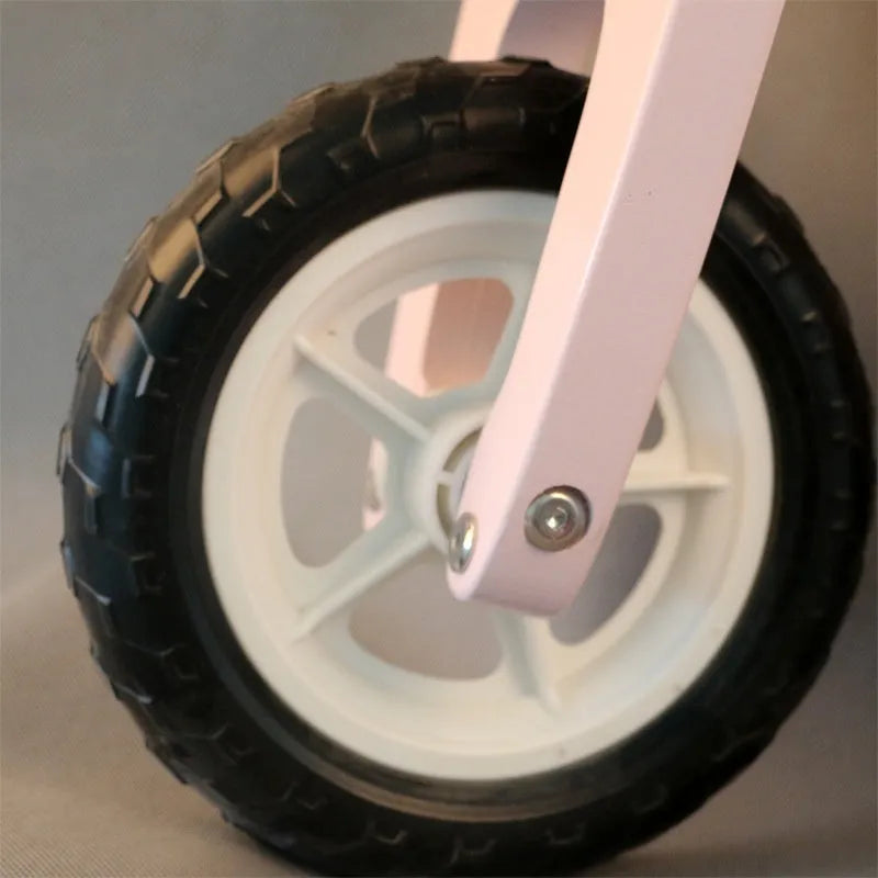 Pink wooden balance scooter for toddlers, 10 inches long, for children aged 1-6 years.