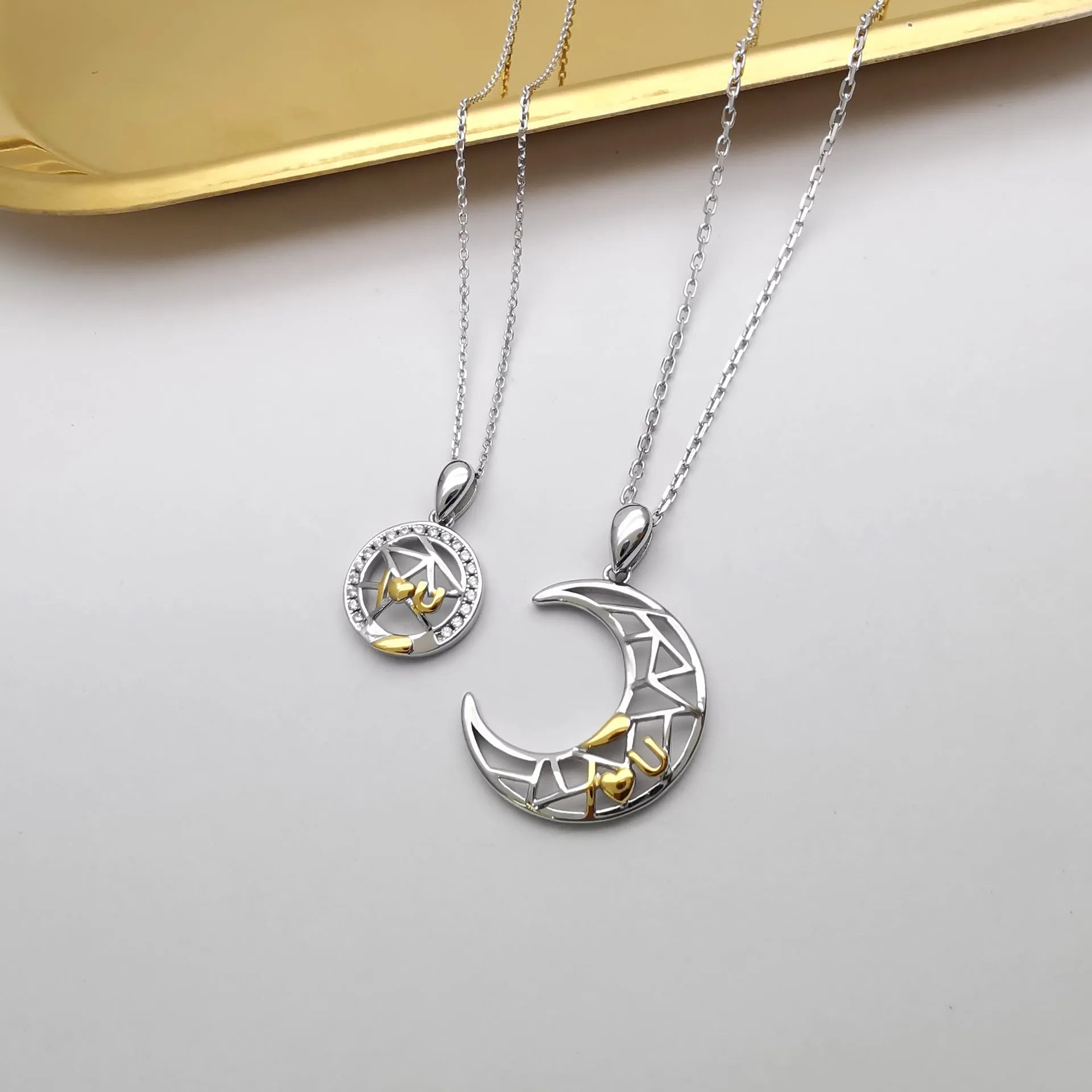 Copper sun and moon tooth couple necklace set with electroplated finish on a cross chain.