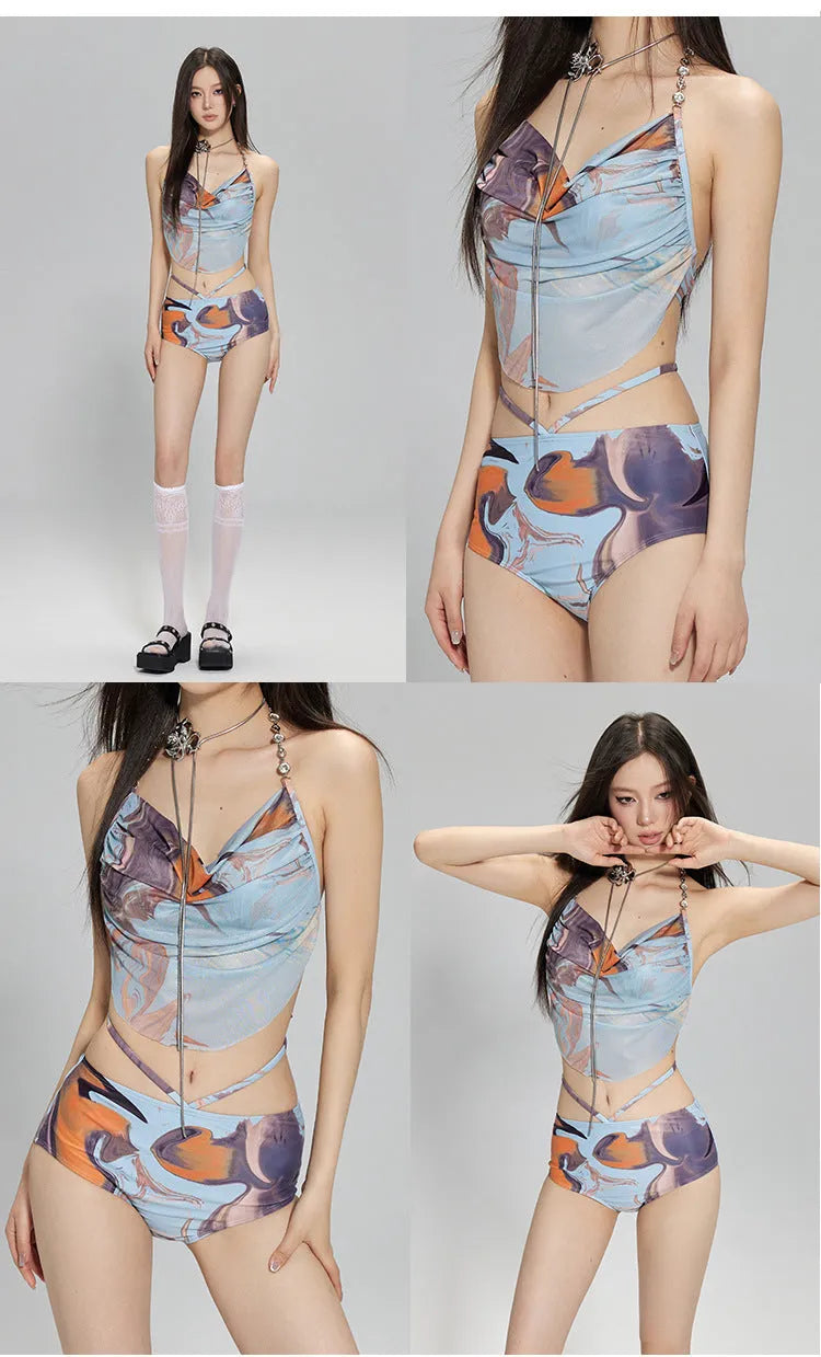 Blue printed women's three-piece bikini set with triangle top, high-waisted briefs, and skirt on hanger.