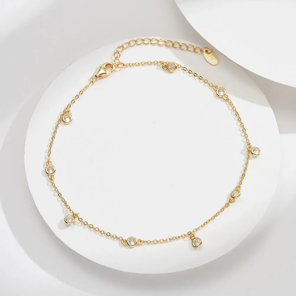 Women's sterling silver anklet with a small geometric zirconium pendant in a gold or white gold colour.