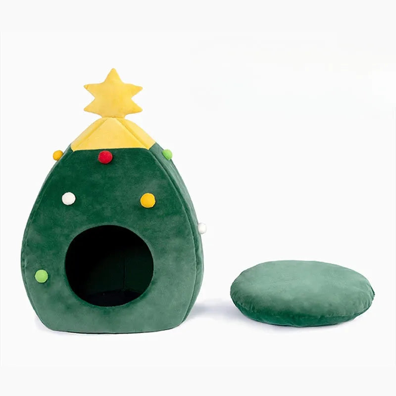 Red Christmas tree shaped plush cave bed for cats and small dogs on a wooden floor.