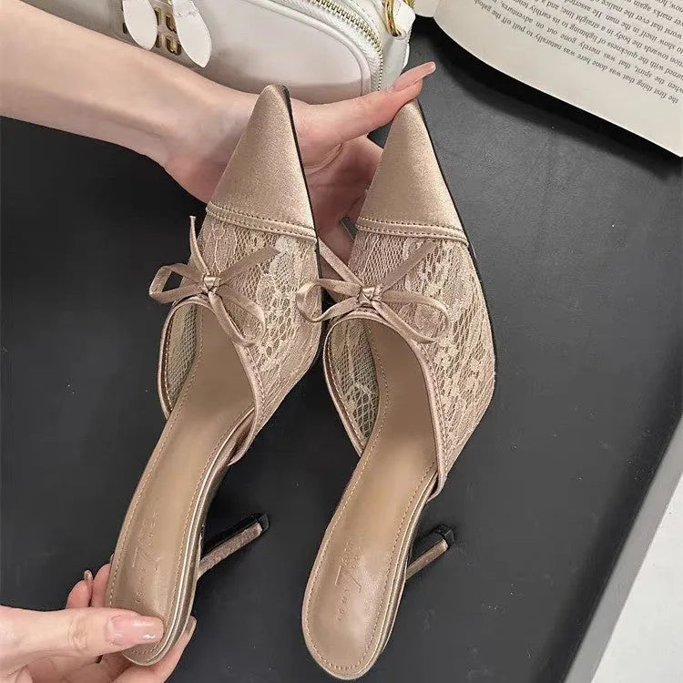 Light brown women's lace high heels with a pointed toe and a decorative bowknot on the upper.