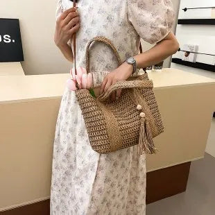 Large straw crossbody bag with woven raffia construction and polyester lining