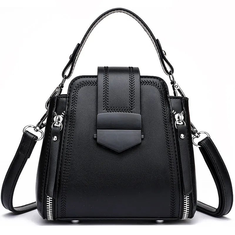 Small square vertical handbag in soft textured PU leather with sewing thread detail.