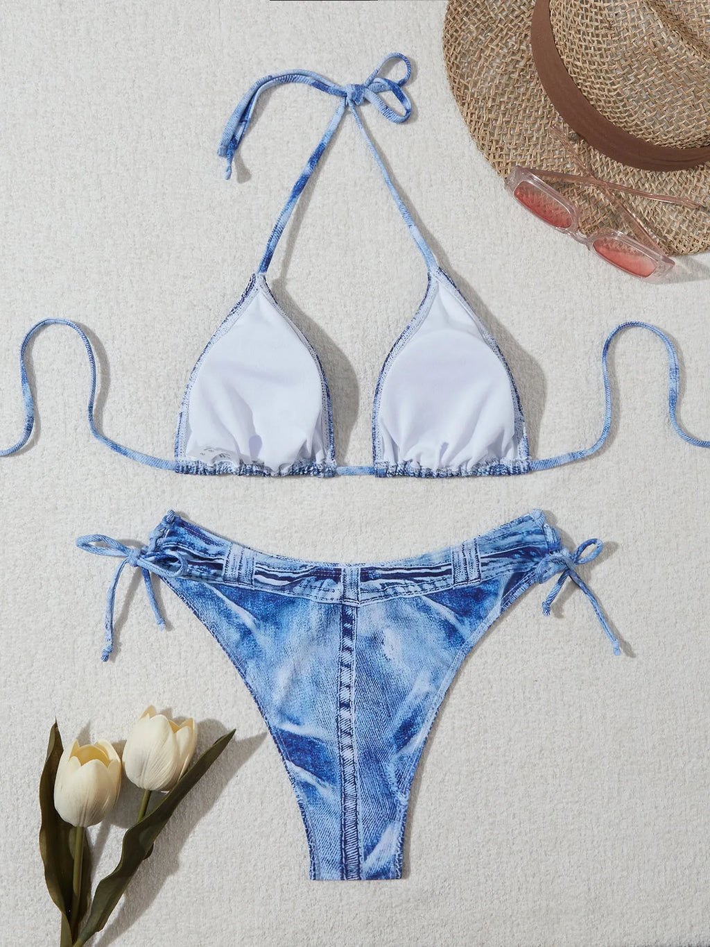 Denim blue women's bikini set with printed strap design on a hanger.