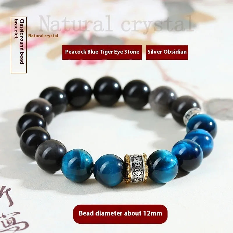 Handmade geometric Peacock Blue Tigereye stone bracelet with round beads on a wrist.