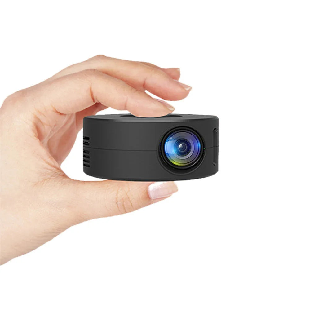 Black portable children's home projector for mobile phone connection on a surface