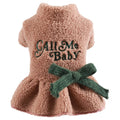 Pet dog wearing a pink baby letter patterned fleece skirt, showing the casual fit and soft polyester material.