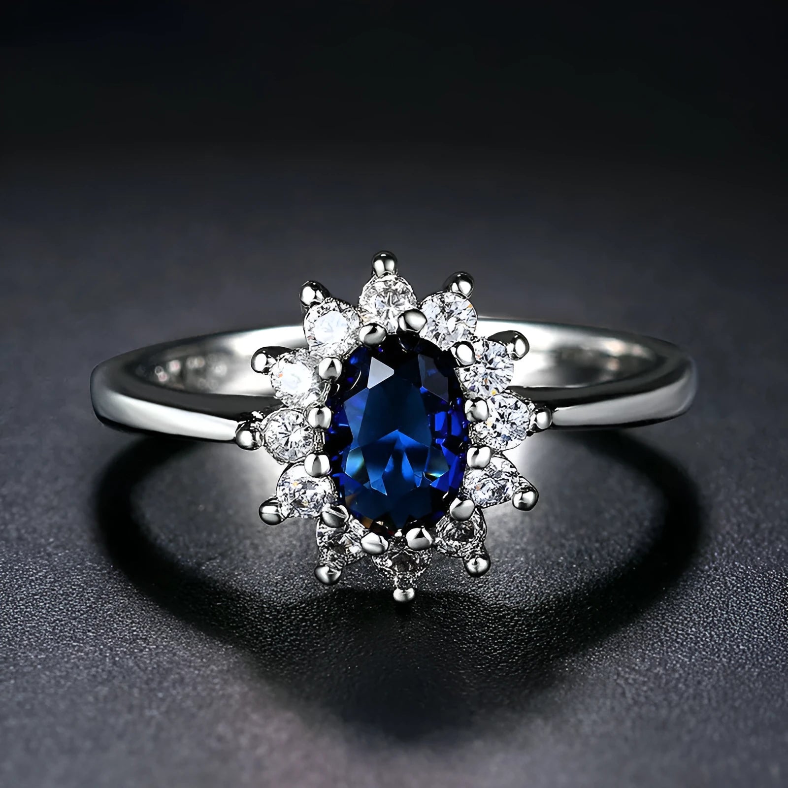 Women's flower-shaped moissanite ring in electroplated copper, shown in sapphire blue colour on a hand.