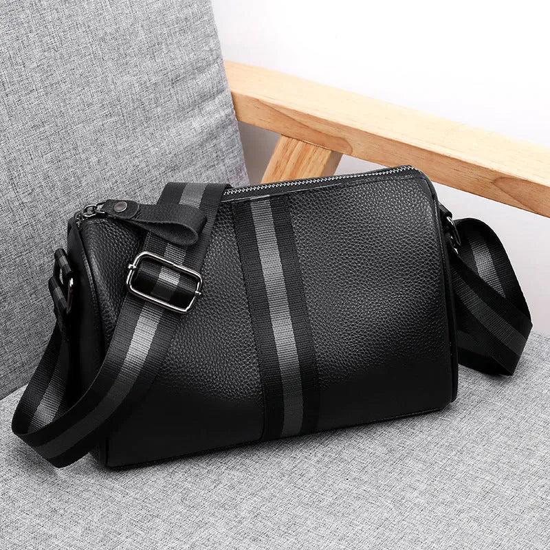 Black genuine leather crossbody shoulder bag showing front view and dimensions