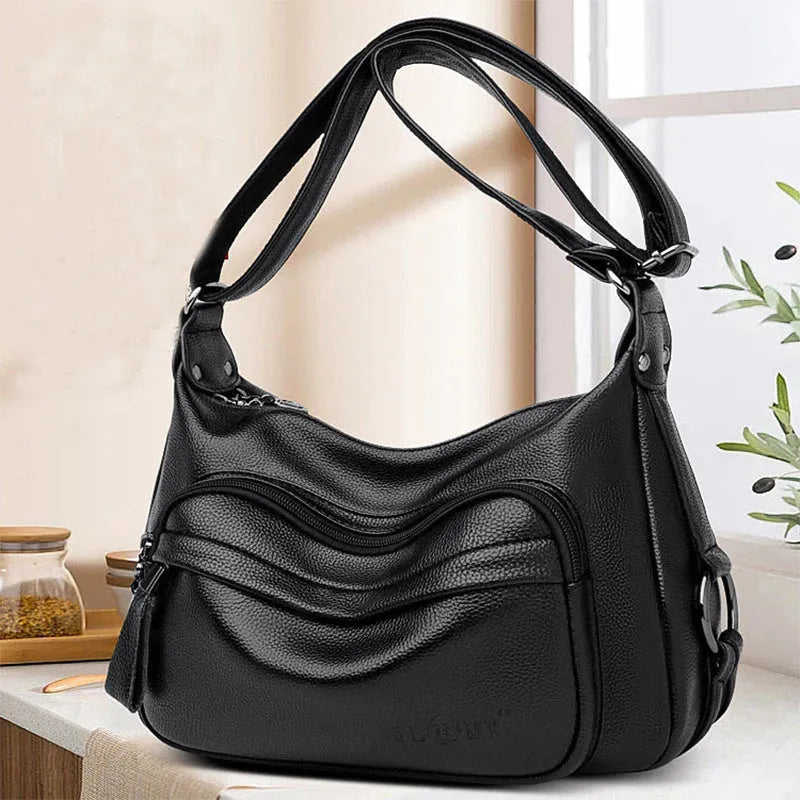Large blue PU crossbody shoulder bag with multiple internal compartments and luggage-style design