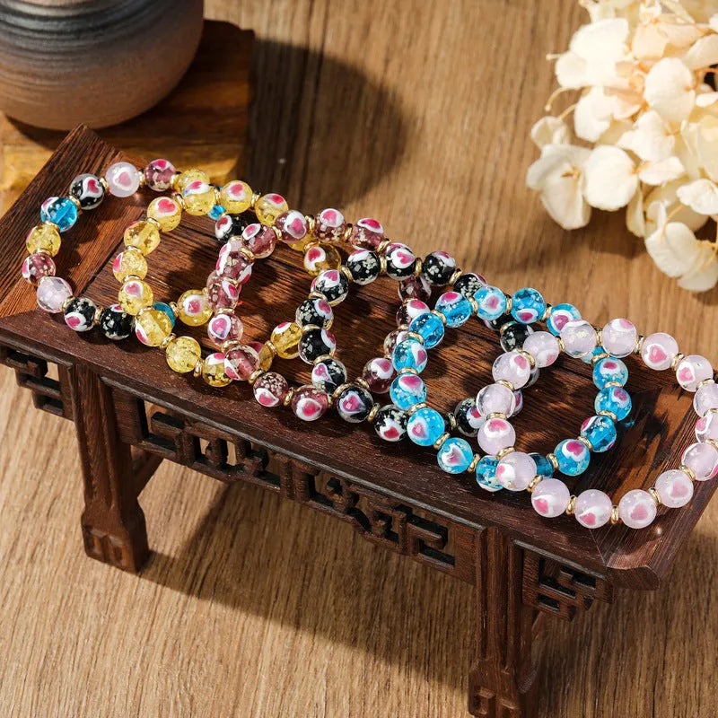 Handmade glass bracelet with swallow gold beast motifs and 10mm heart-shaped beads in multiple colour options