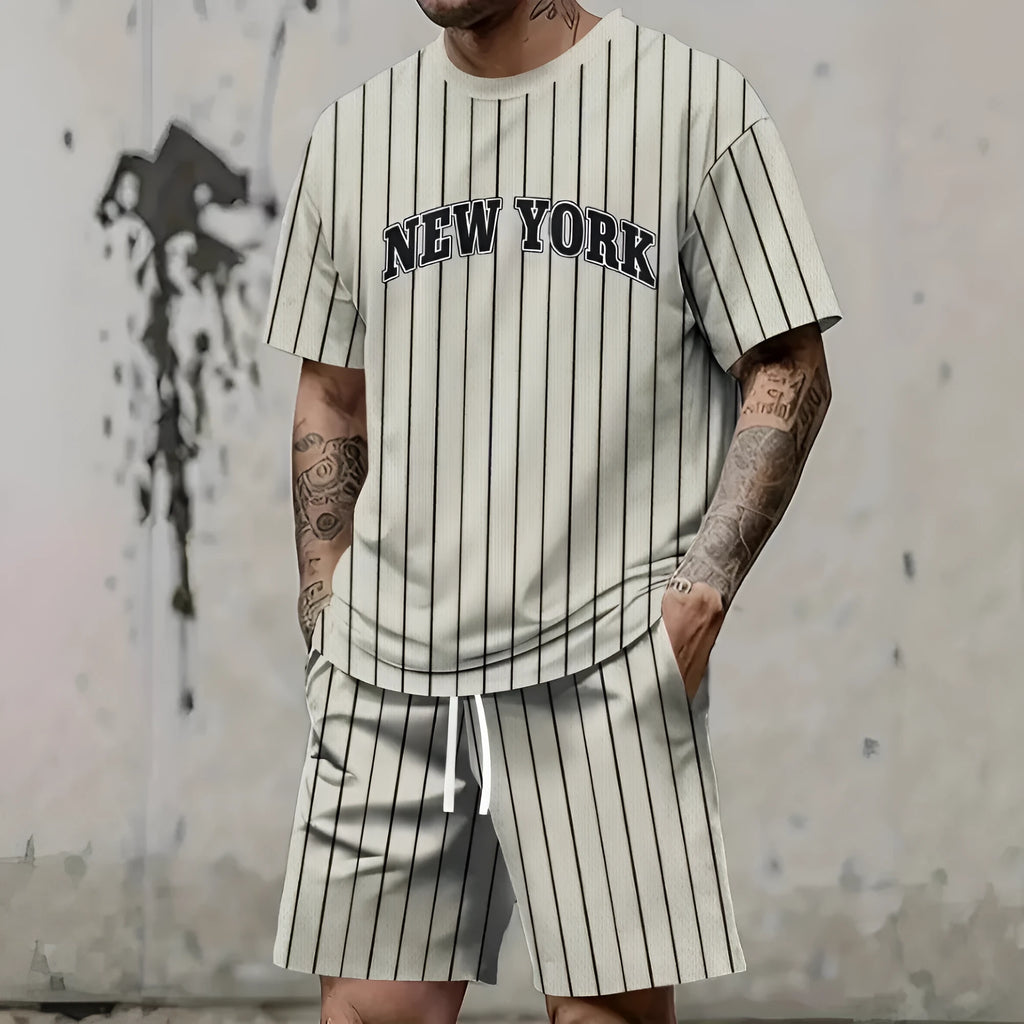 Men's grey sports suit with 3D printed text on the chest, showing short sleeve top and matching shorts.