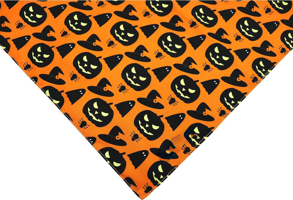 Black and orange reversible Halloween dog bandana with pumpkin and spider web patterns on a dog.