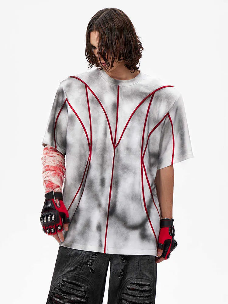 Padded shoulder short sleeve T-shirt with three-dimensional line patchwork detail on a round neck.