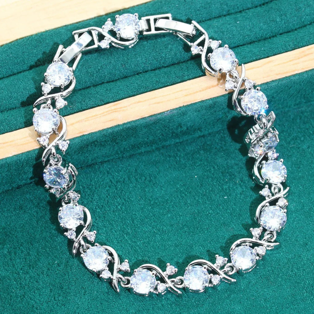 Bridal zircon jewellery set showing necklace, earrings, bracelet, and ring pieces with water wave chain design