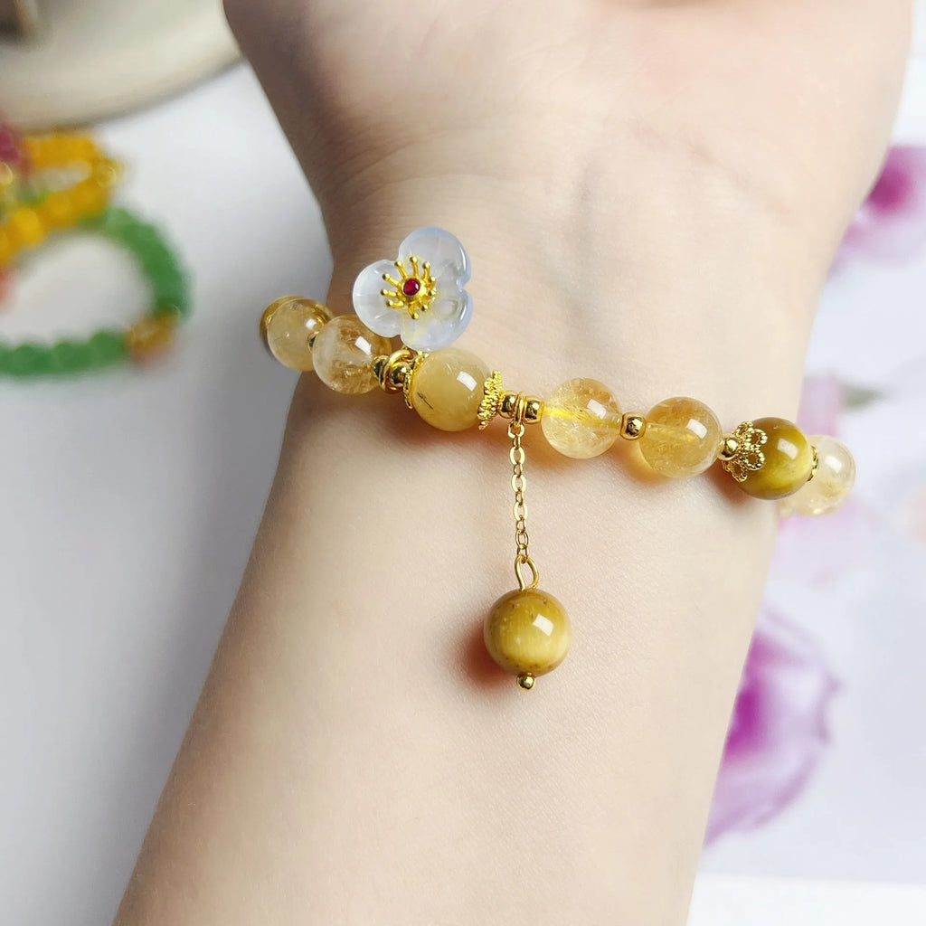 Golden yellow citrine crystal bracelet with flower and tassel detail for women.